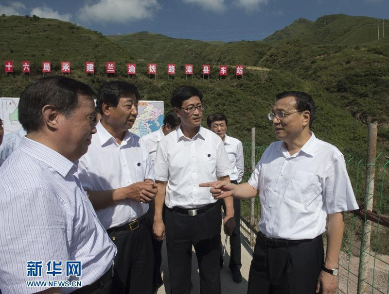 8月17日至19日，中共中央政治局常委、國務院總理李克強到甘肅定西、蘭州考察。這是8月18日，李克強在蘭渝鐵路漳縣火車站施工現場向中國鐵路總公司負責人了解西部地區(qū)鐵路規(guī)劃建設情況。新華社記者 李學仁 攝