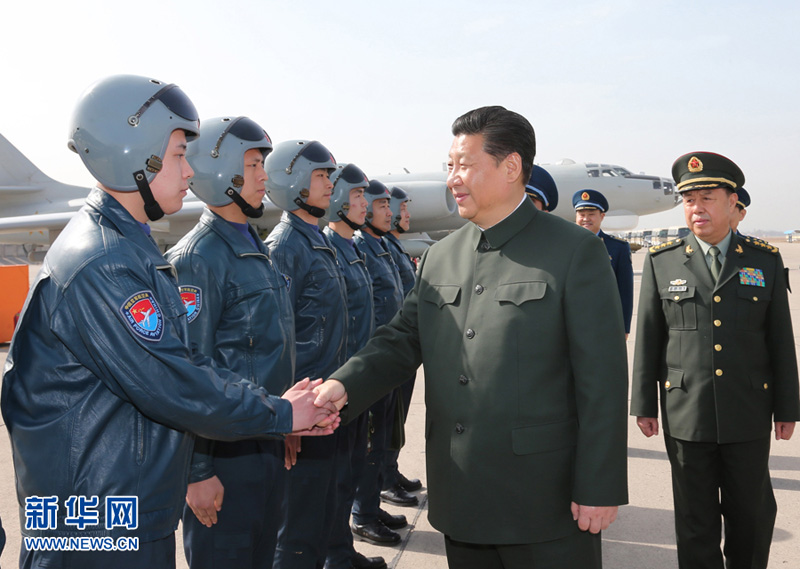 2015年2月16日，習近平同空軍航空兵某團飛行機組和機務人員握手交談。李剛攝