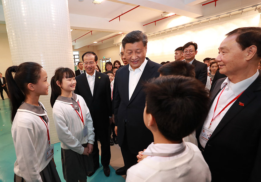 12月19日，國家主席習近平在澳門特別行政區行政長官崔世安陪同下，來到位於澳門黑沙環的政府綜合服務中心和濠江中學附屬英才學校，同澳門市民和師生親切交流。離開濠江中學附屬英才學校時，師生們圍攏過來，向習近平主席熱情問好。 新華社記者 龐興雷 攝
